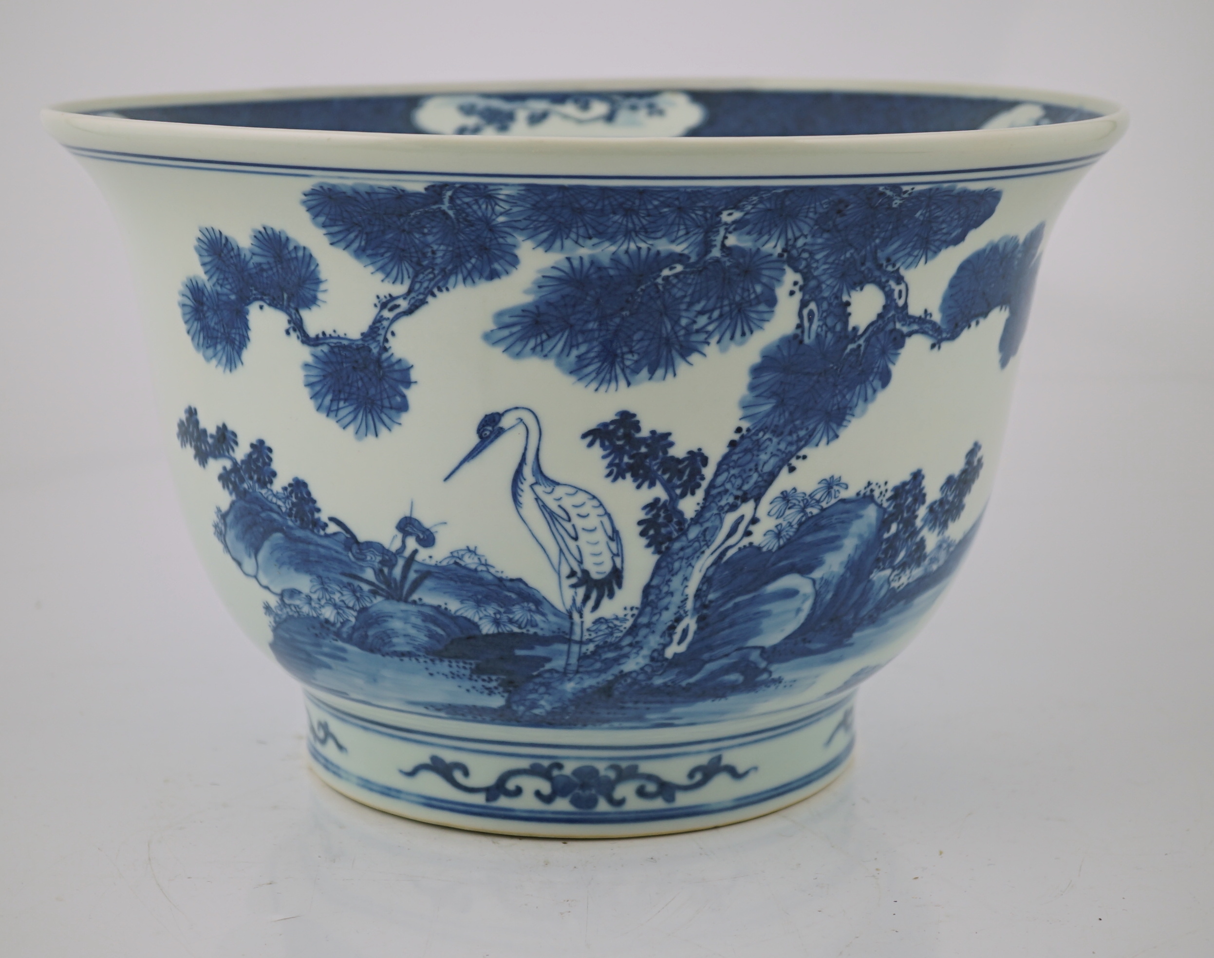 A Chinese blue and white 'deer and cranes' planter, 19th century, restoration to rim and a crack to the base
